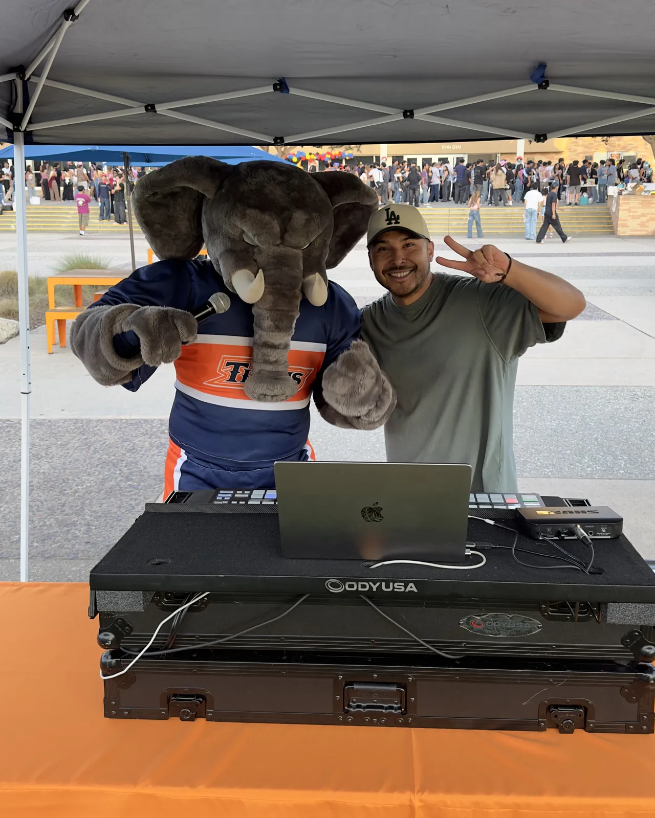 DJ Lowso and Tuffy the Titan, Cal State Fullerton’s mascot, behind the DJ booth at a campus event