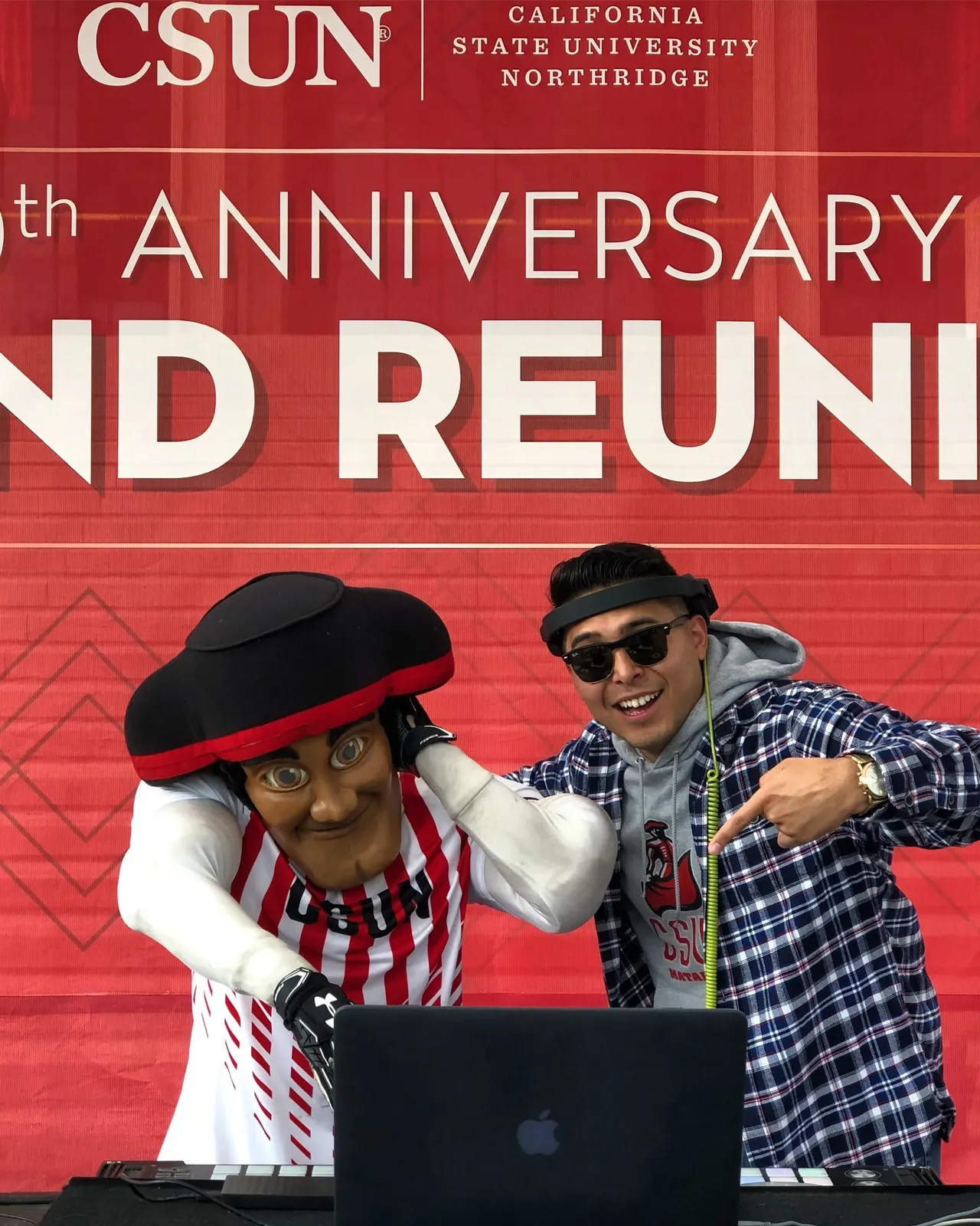 DJ Lowso at his setup with the CSUN Matador mascot in front of a Grand Reunion backdrop