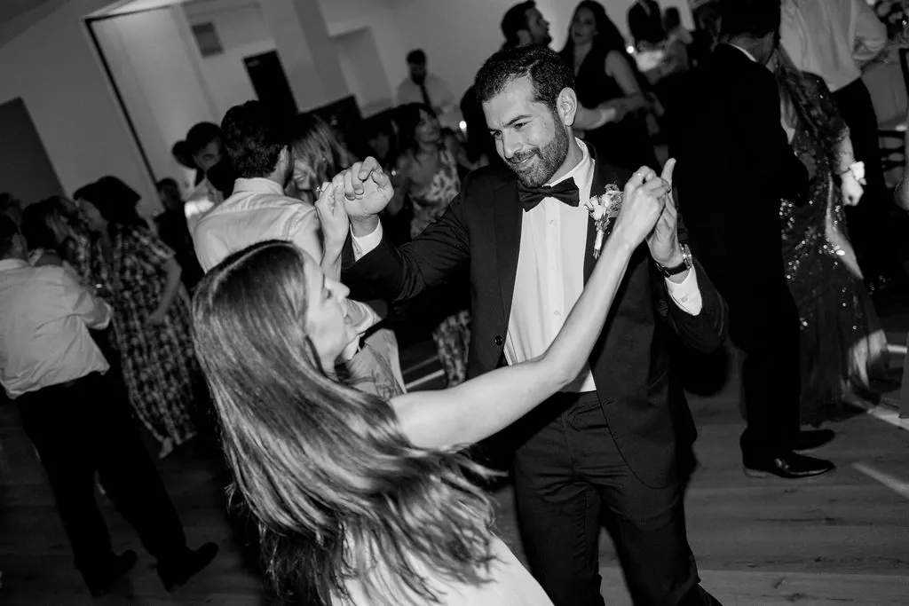 Black and white photograph of a couple dancing, caught mid-motion