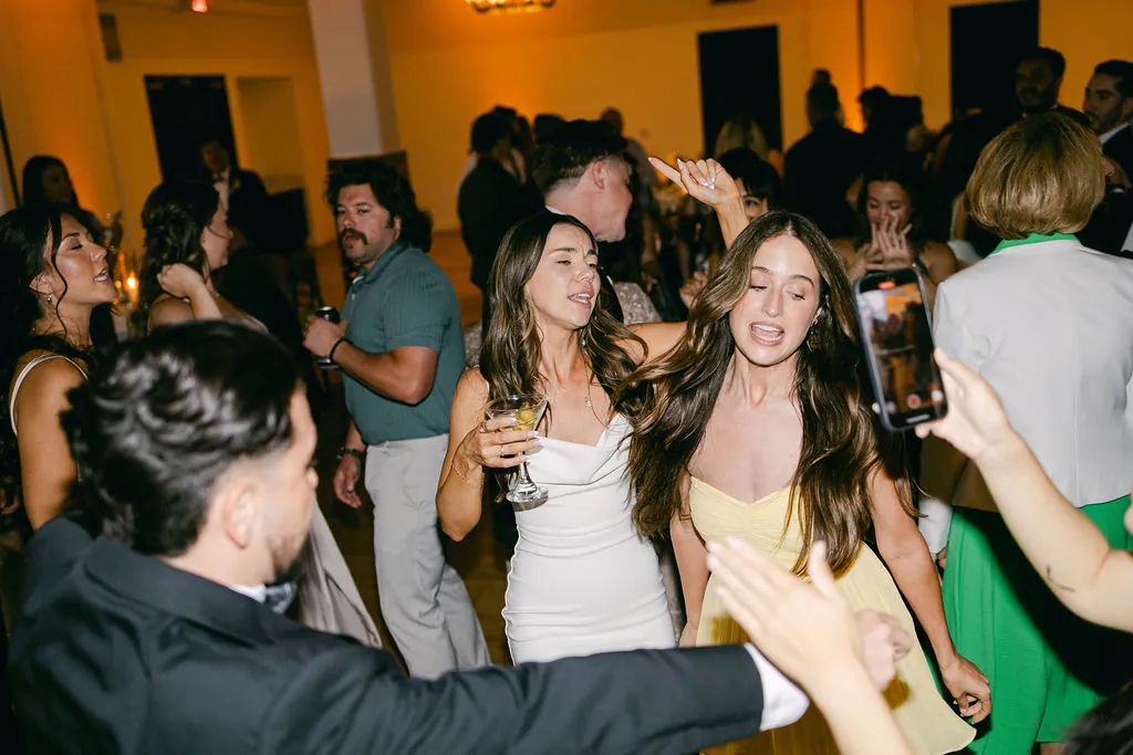 Guests dancing closely together at a wedding reception