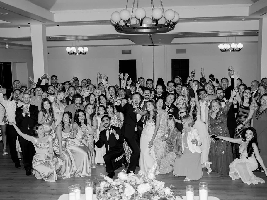 Black-and-white photo of the whole wedding party and guests on the dance floor at Spanish Hills Club in Camarillo